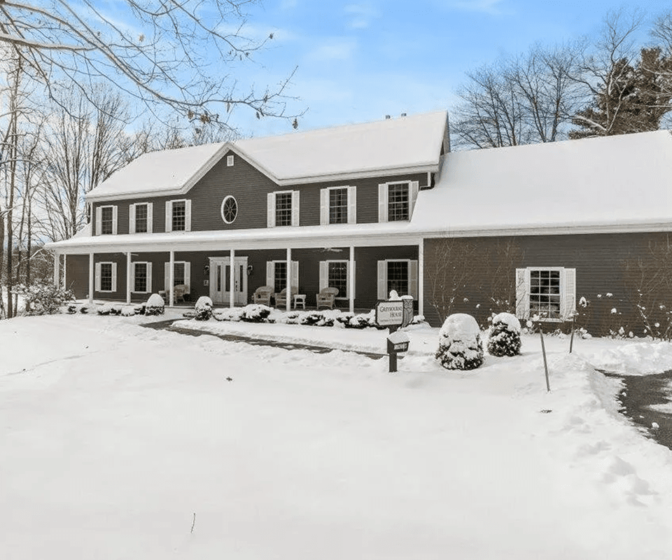 Colonial-style home in snowy landscape